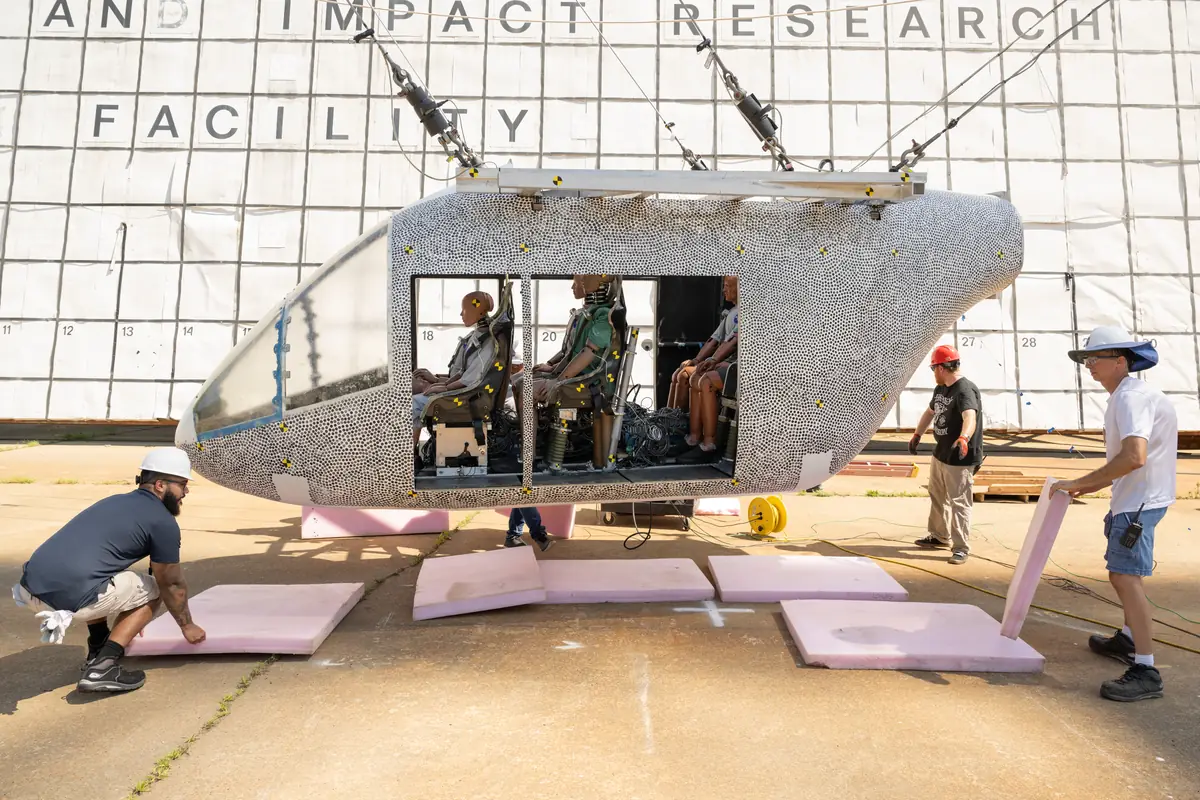 Researchers at NASA Langley preparing a full-scale air taxi body with test dummies inside for a drop test