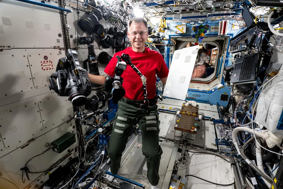 Astronaut Nick Hague testing a student-designed utility bracket inside the International Space Station