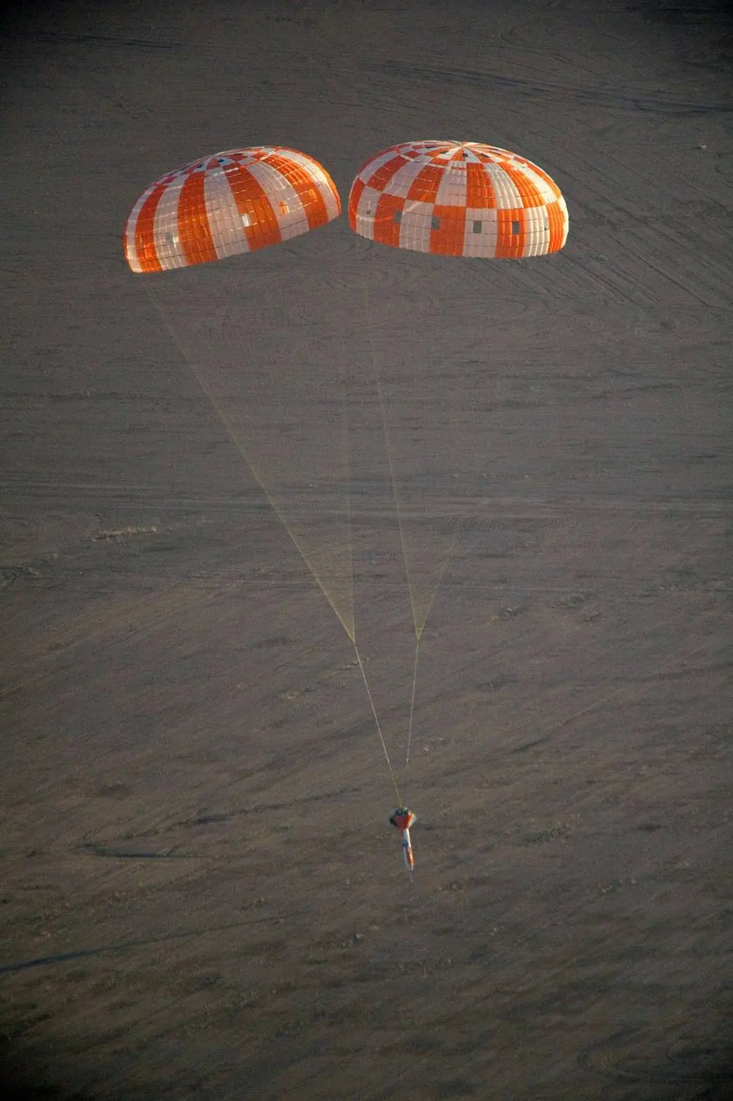 An Orion test article descending under two parachutes during a drop test over Yuma, Arizona